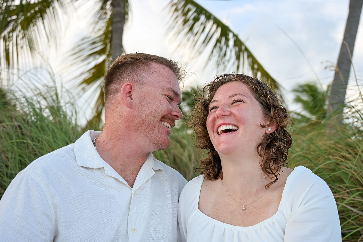 Engaged couple laughing together during a Key West beach session